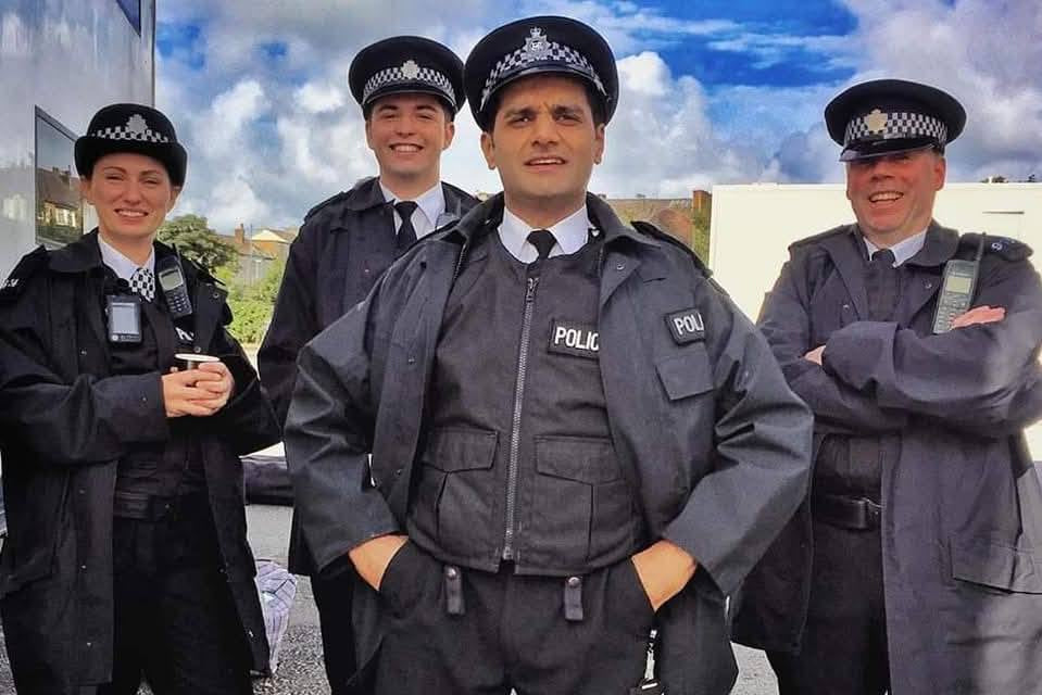 5 Police stand smiling